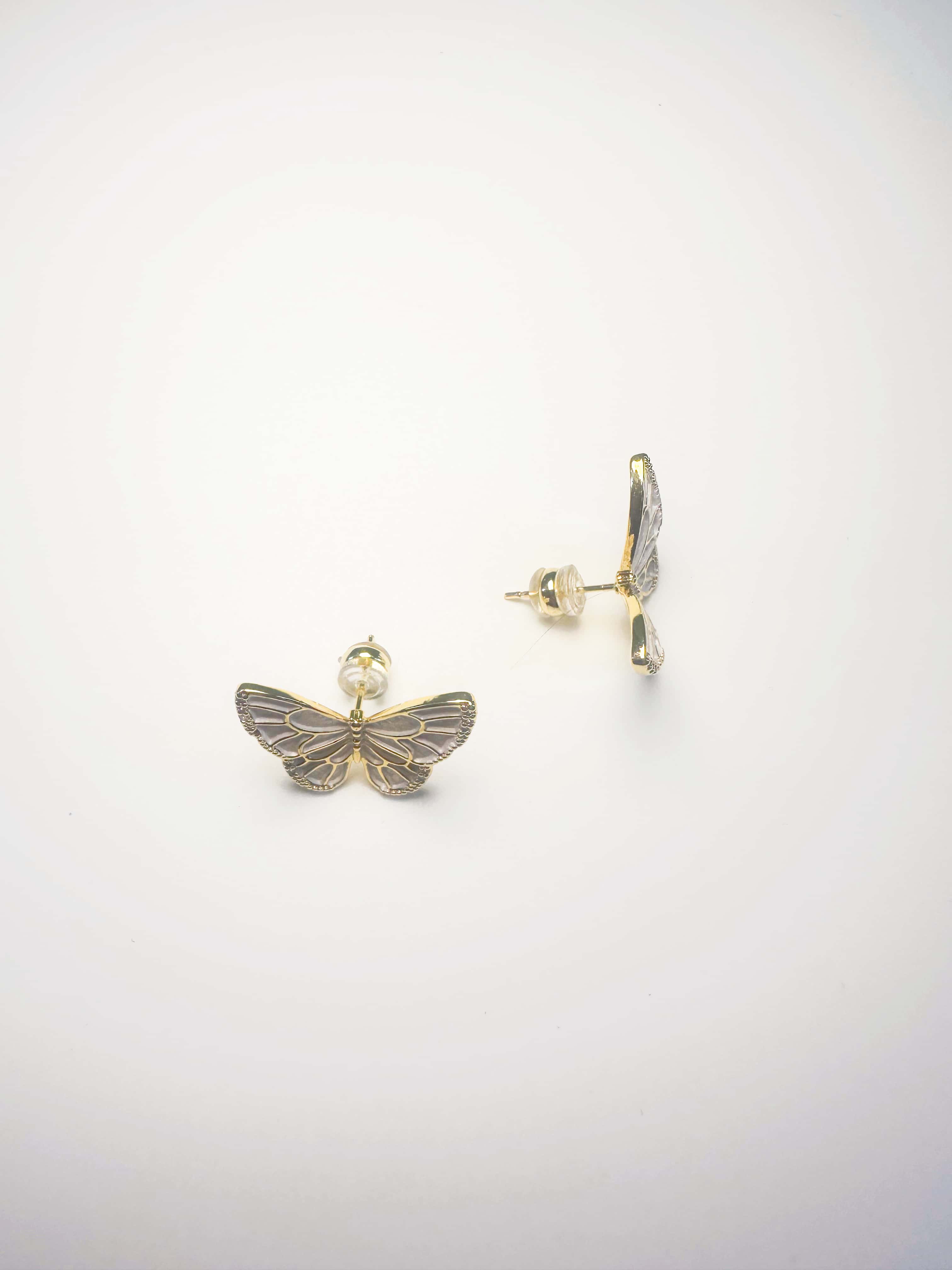 A pair of elegant 18K gold butterfly earrings with vibrant enamel detailing, displayed on a clean white background showing the front and back craftsmanship