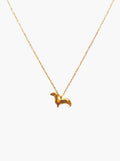 gold dachshund necklace against a white background
