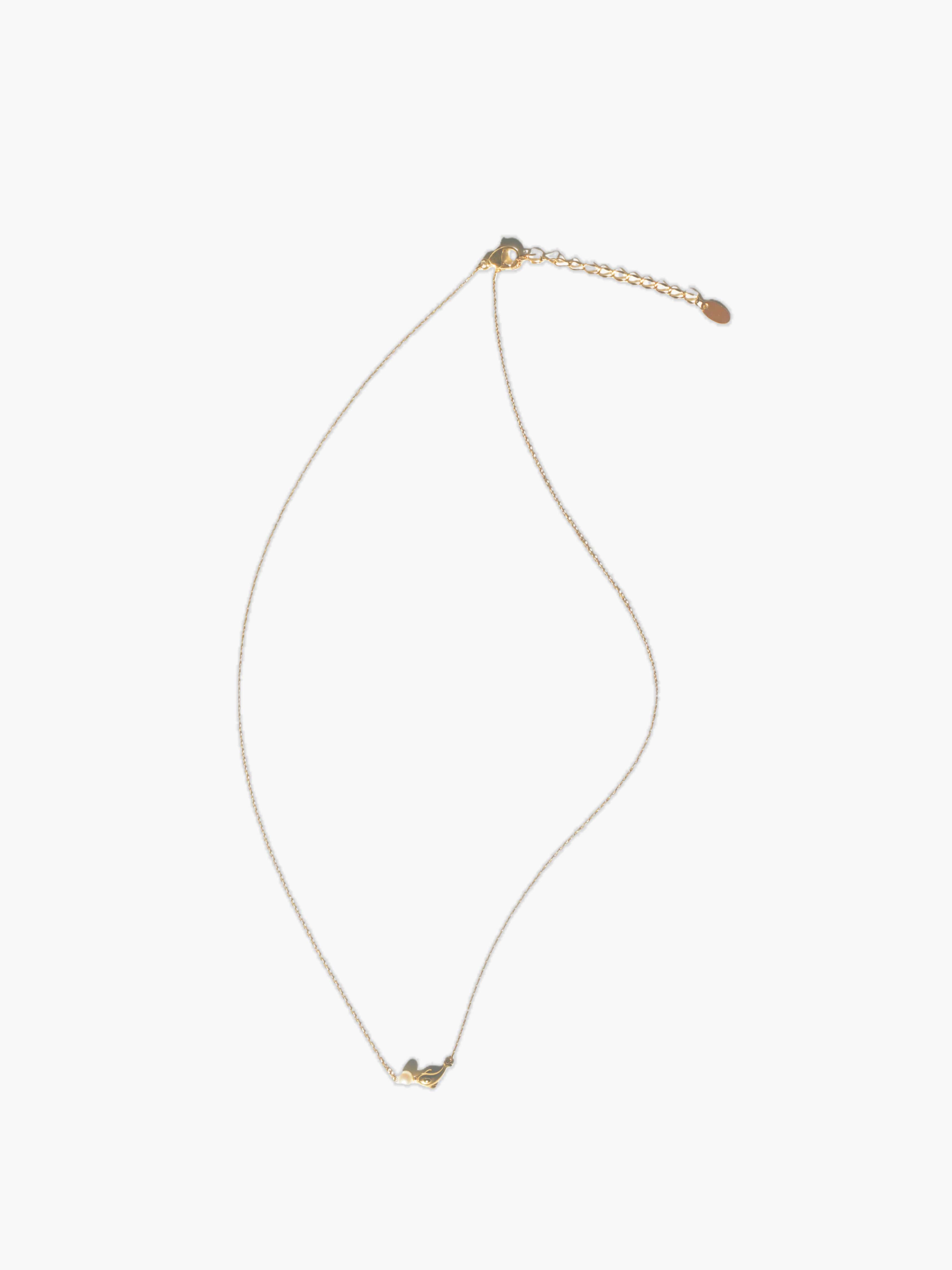gold dolphin pendant necklace on a white background