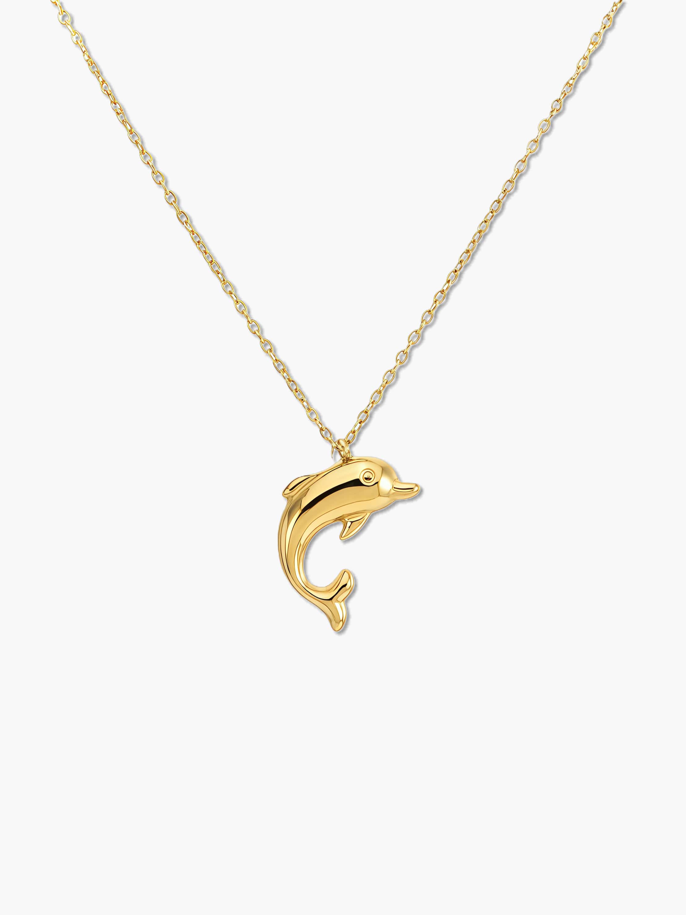 gold dolphin pendant necklace on a white background