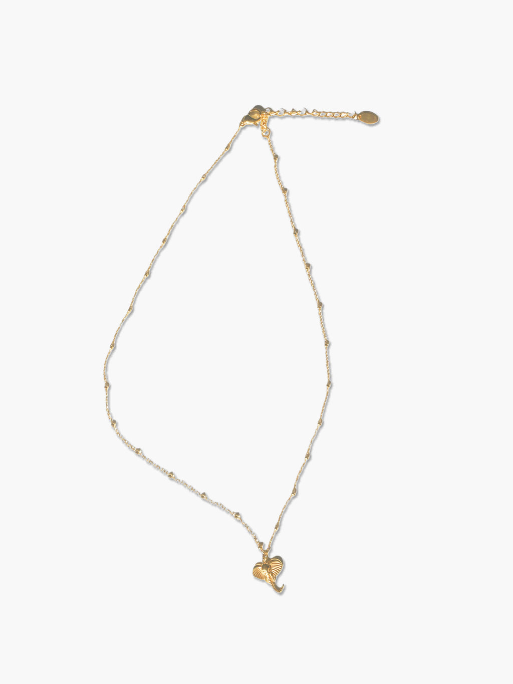 Gold necklace with a elephant-shaped pendant on a white background
