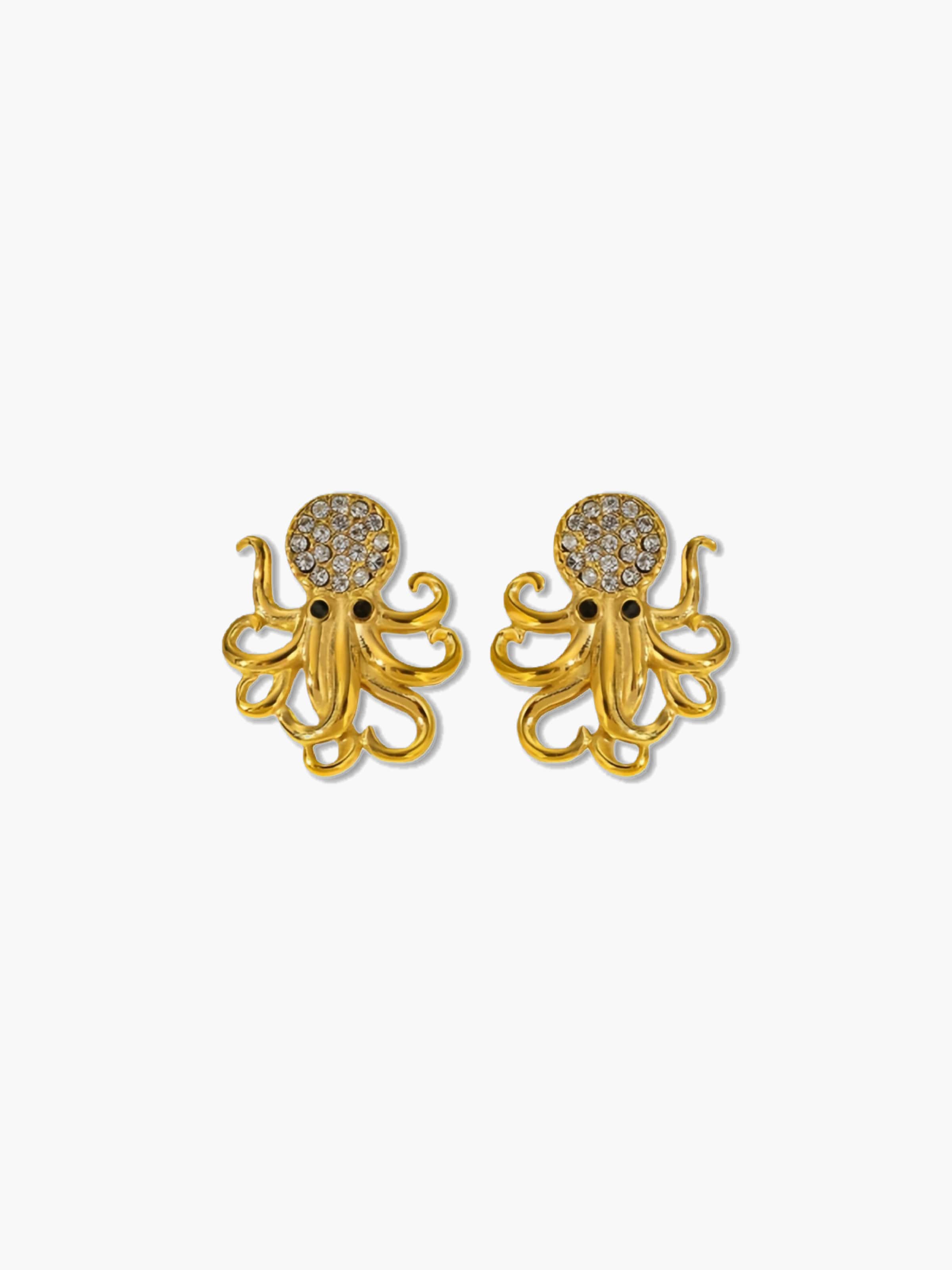 Gold octopus earrings with gemstone details on a white background