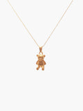 gold teddy bear pendant necklace against a white background