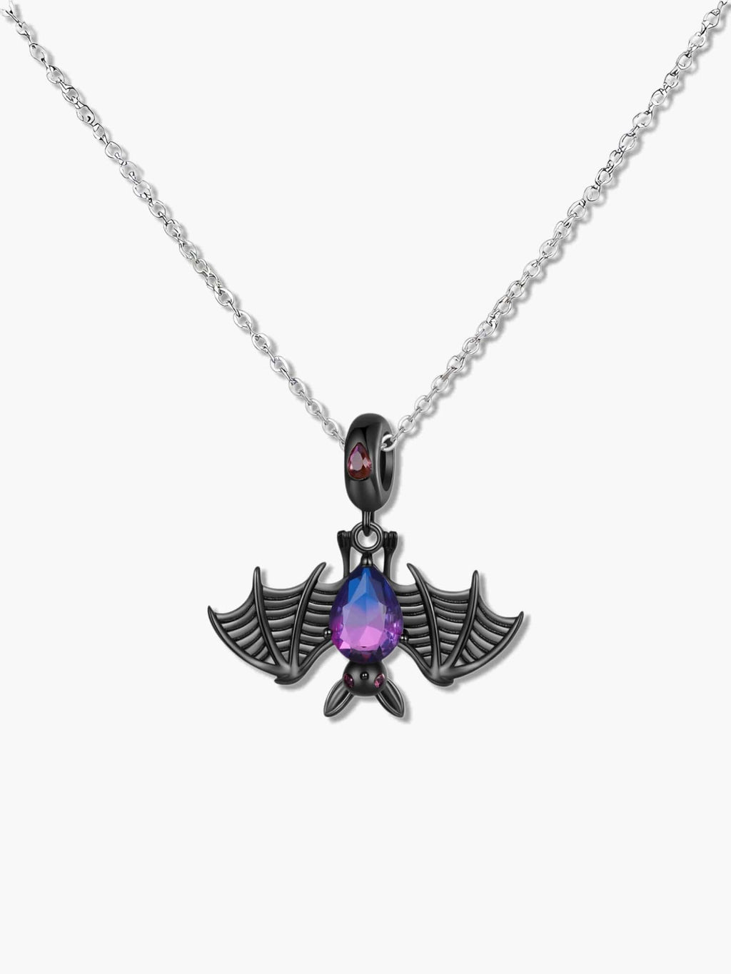 Close up of a gothic bat necklace featuring an oxidized S925 silver bat holding a purple synthetic tourmaline teardrop stone