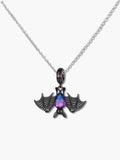 Close up of a gothic bat necklace featuring an oxidized S925 silver bat holding a purple synthetic tourmaline teardrop stone