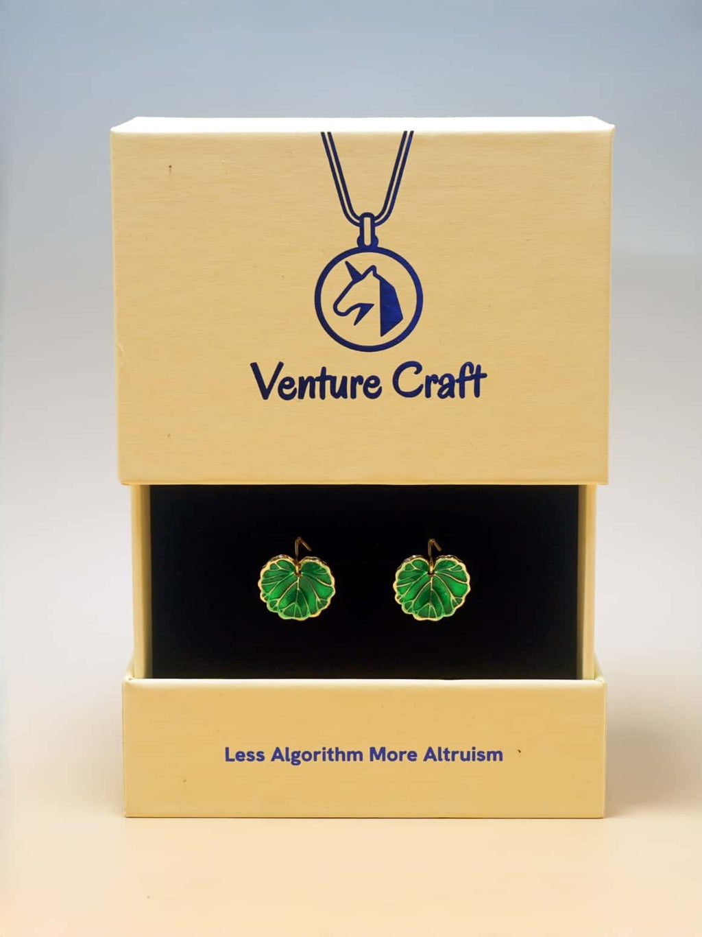 Green leaf earrings in a Venture Craft box with a blue logo.