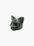 Hand-carved dark green crystal cat figurine featuring third eye engraving on an isolated white background