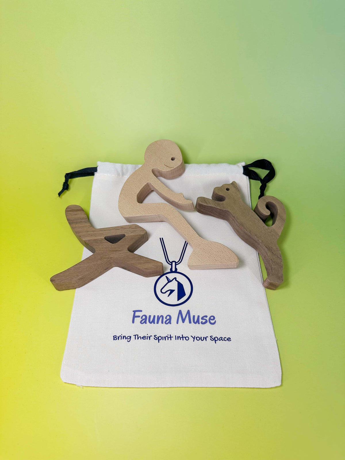 Handcrafted wooden sculpture set of a person interacting with a cat and mini bench with Fauna Muse gift pouch