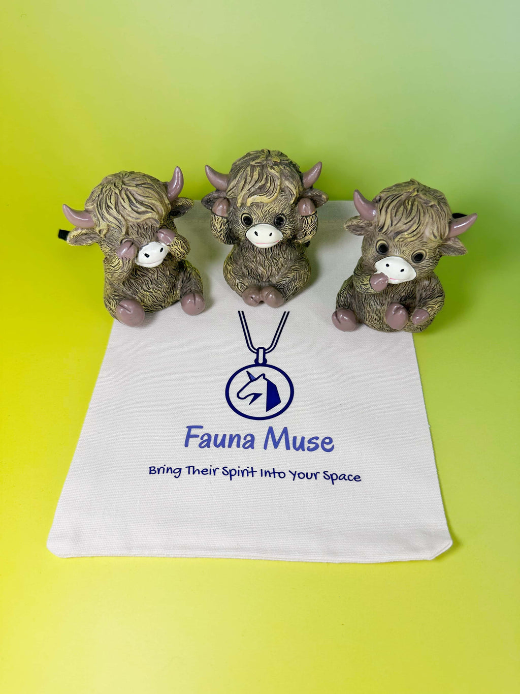 Three mini highland cow figurines set presented with a Fauna Muse canvas gift pouch