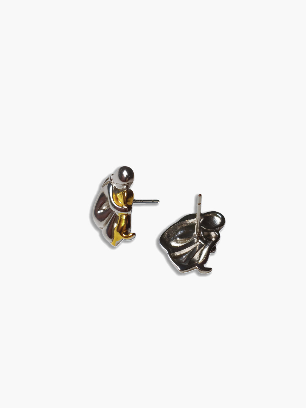 Pair of silver and gold human hug dog earrings on a white background