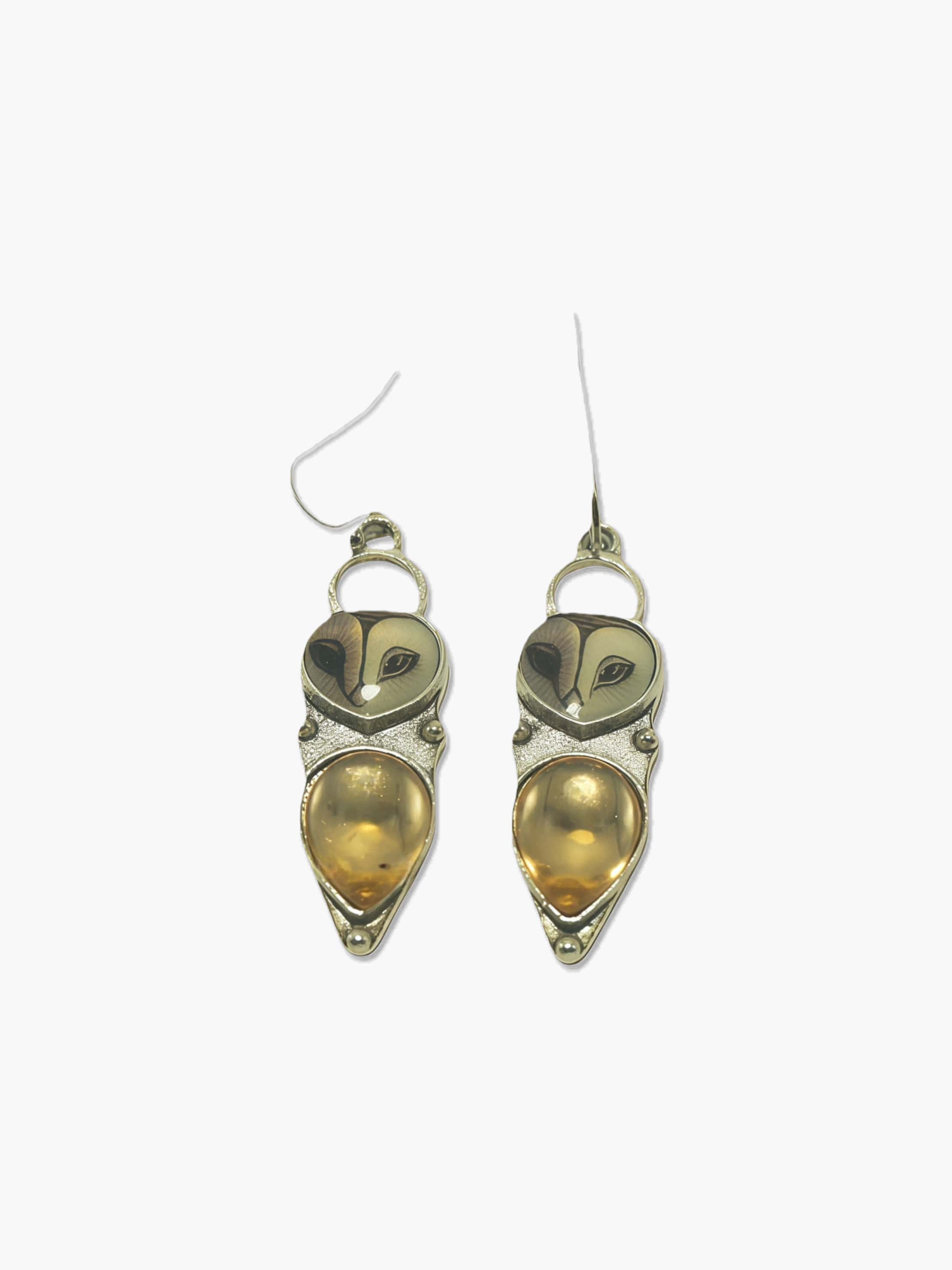 Pair of owl earrings on a white background