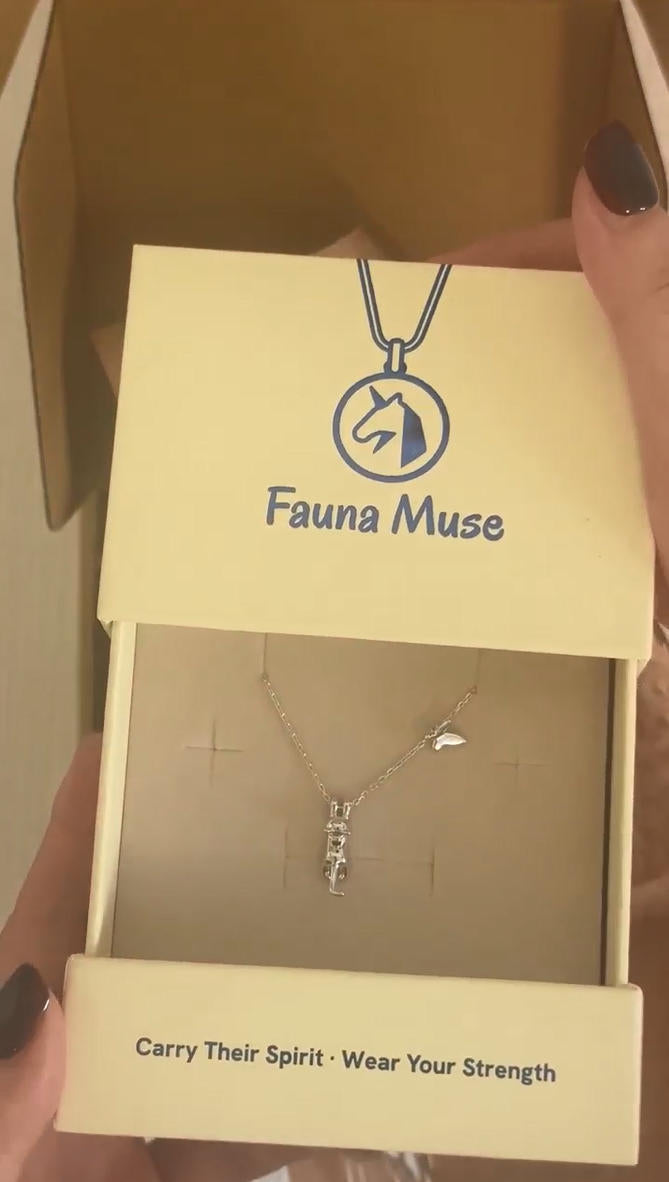 Hands unboxing a Fauna Muse gift box containing a dainty S925 sterling silver cat and butterfly pendant necklace
