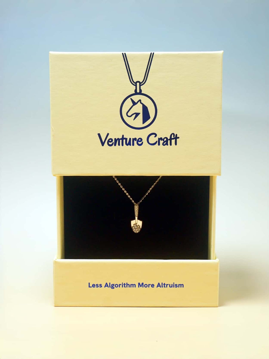 Venture Craft necklace in a box with a blue background