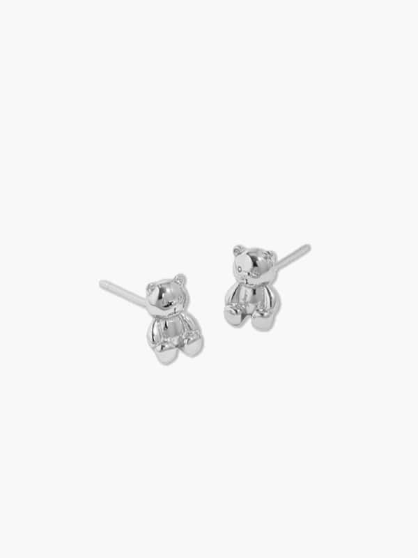 close-up of silver teddy bear earrings 