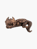 Detailed antique bronze sleeping dragon statue and resin dragon figure showing intricate wings and scales