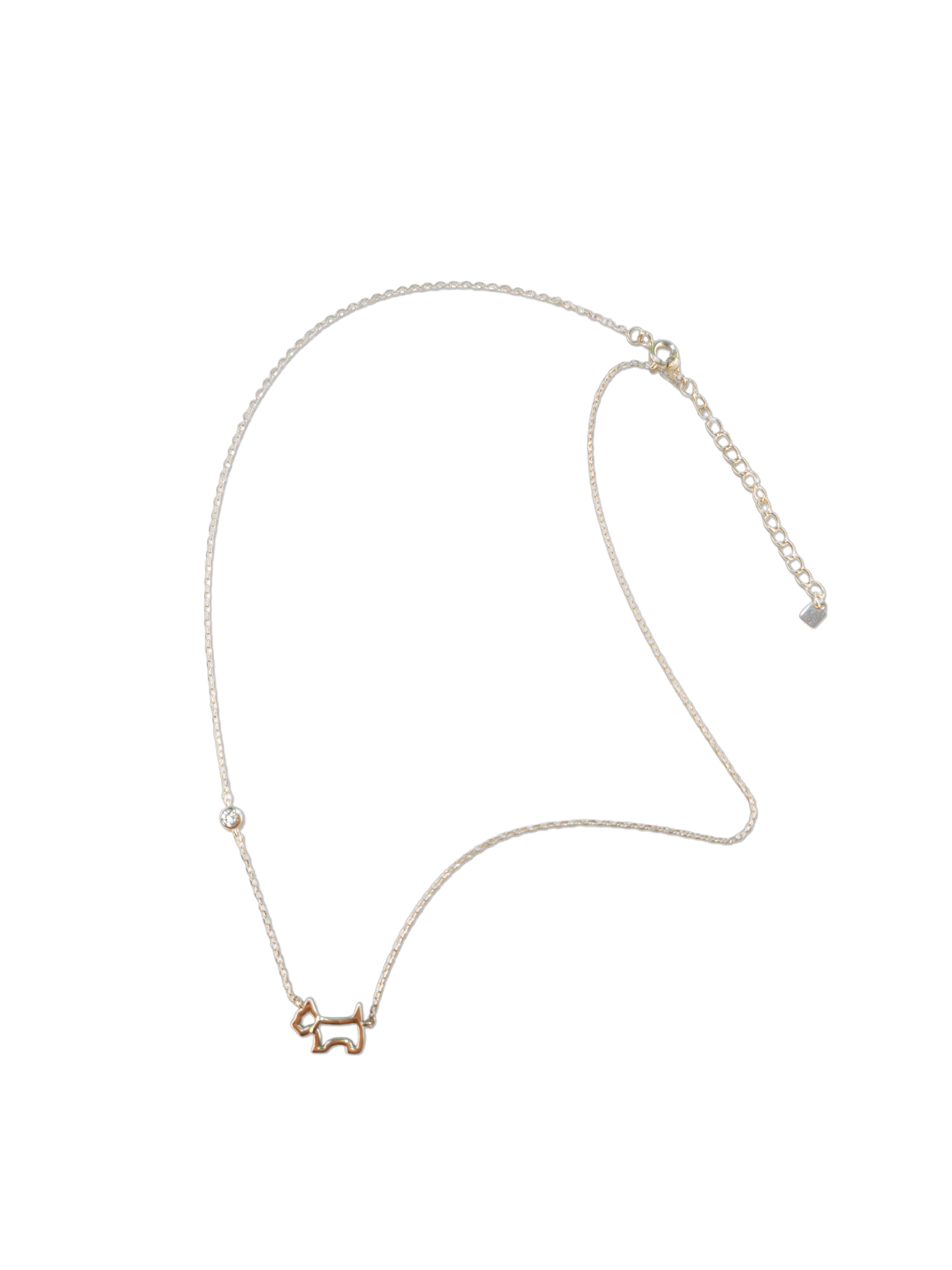 Full flat lay view of a delicate sterling silver dog necklace featuring a cutout puppy design and a bezel-set cubic zirconia accent.