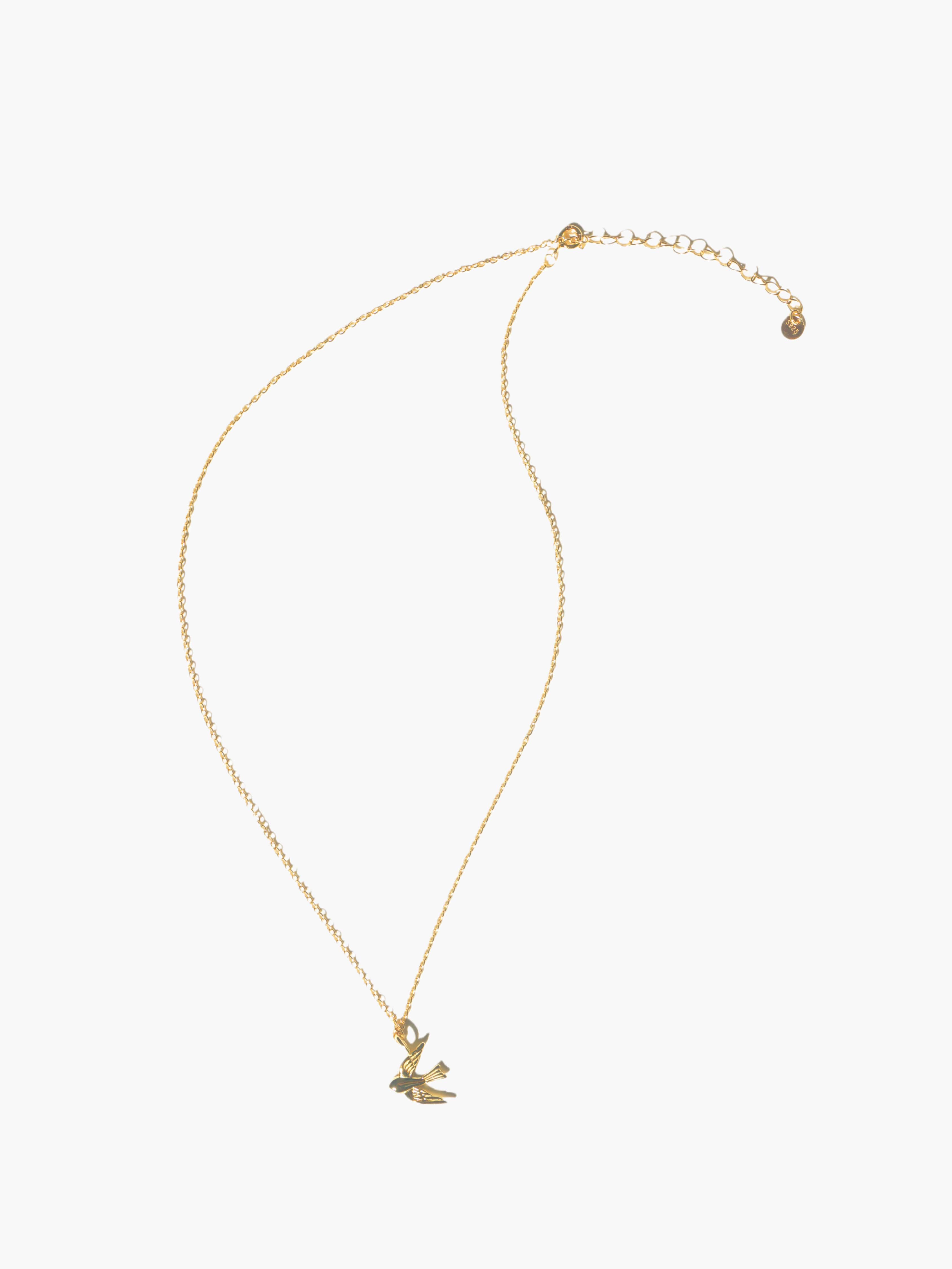gold necklace with a small pendant on a white background