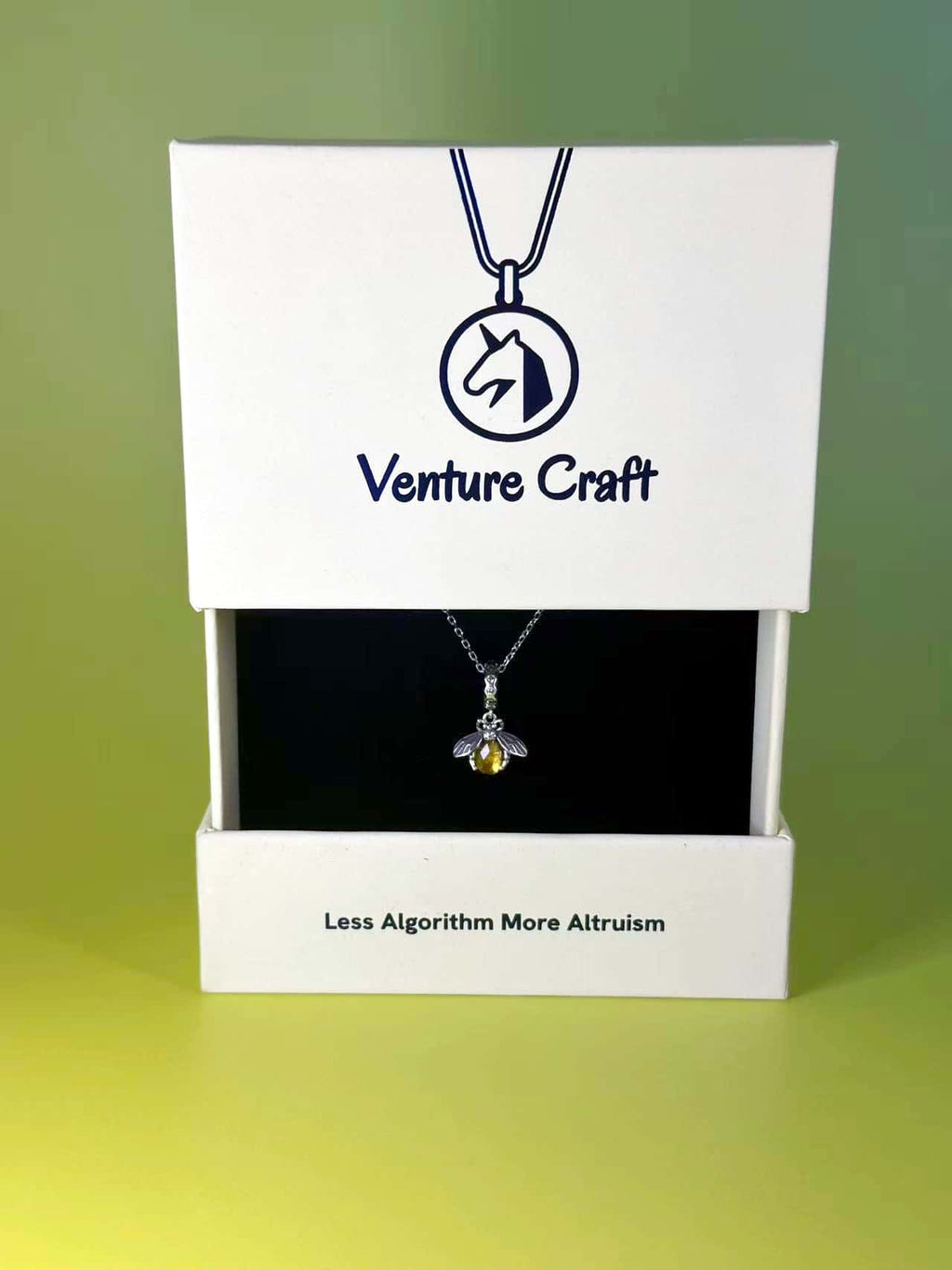The premium bee necklace displayed elegantly inside a white Venture Craft gift box featuring the brand logo and slogan, perfect for jewelry gifting