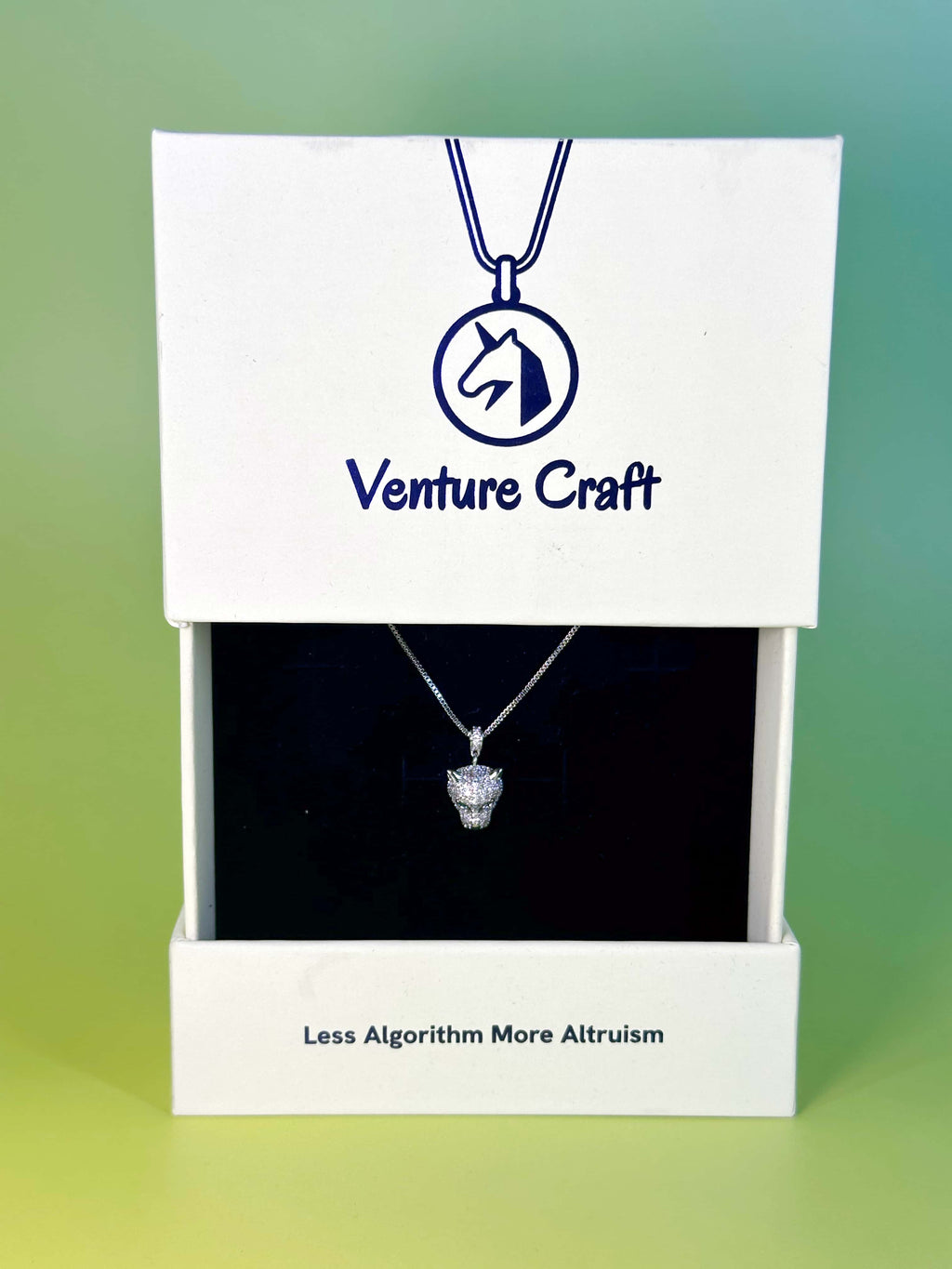 Unboxing of Venture Craft leopard necklace in a white eco-friendly brand box with the slogan Less Algorithm More Altruism printed neatly