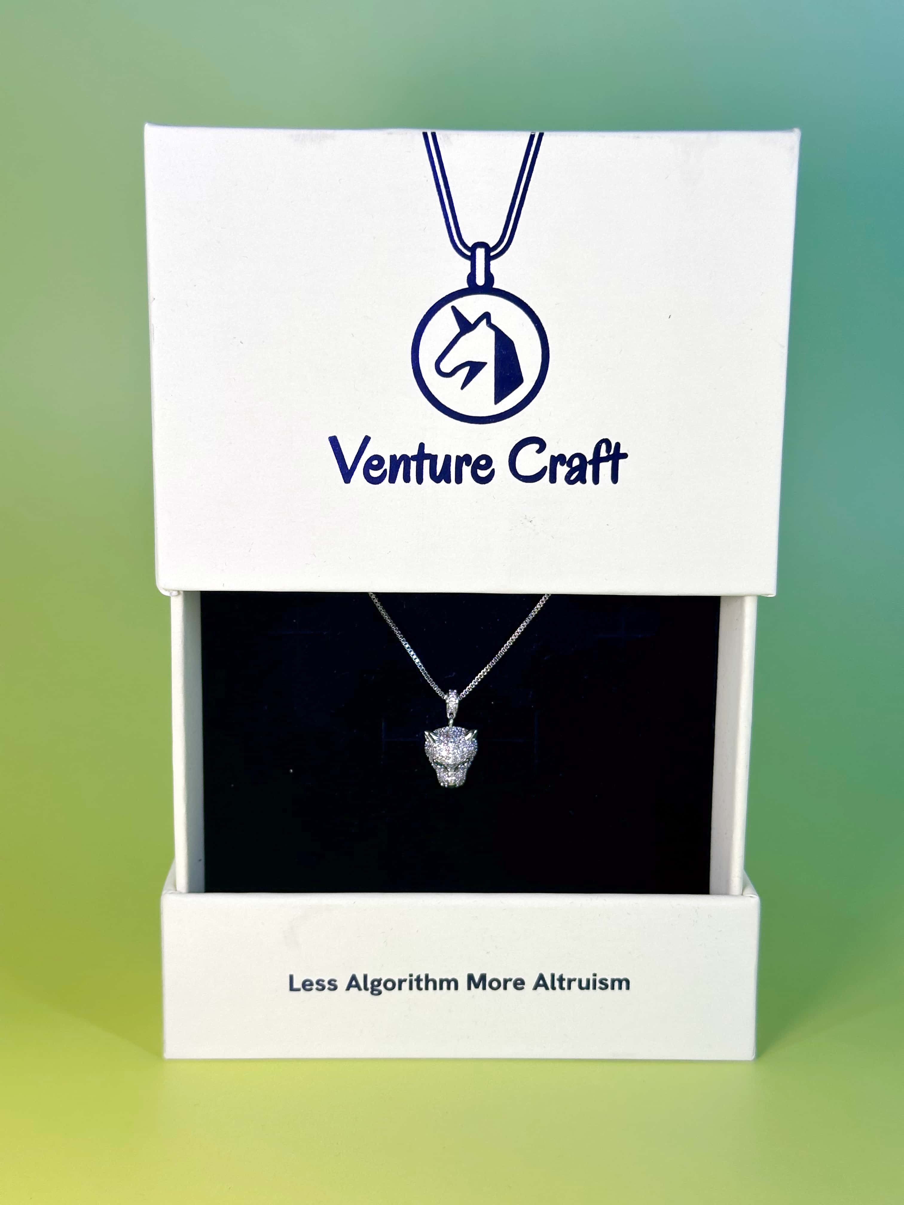 Unboxing of Venture Craft leopard necklace in a white eco-friendly brand box with the slogan Less Algorithm More Altruism printed neatly