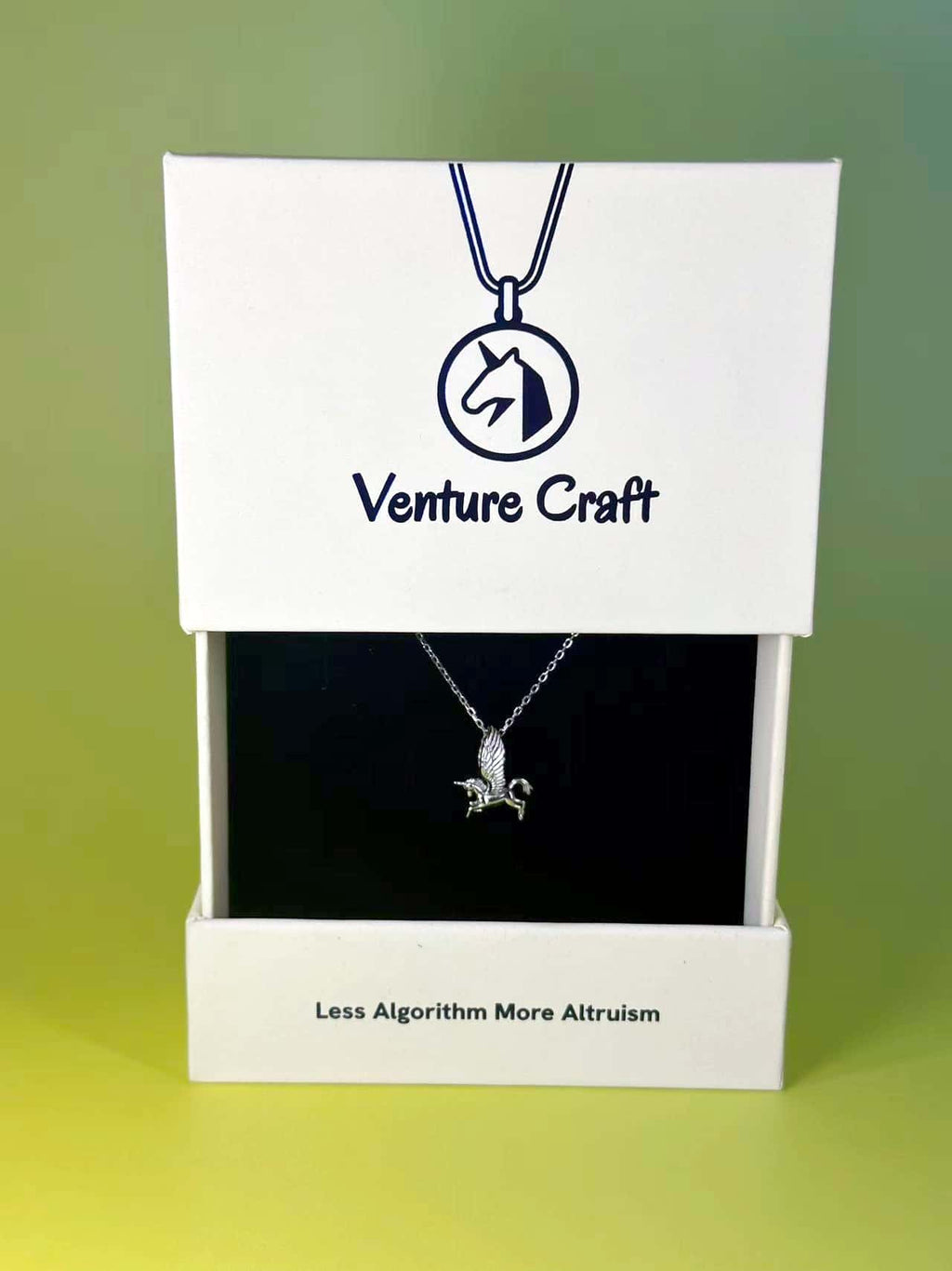 The sterling silver unicorn necklace beautifully packaged in a Venture Craft branded white gift box featuring the brand's altruistic slogan