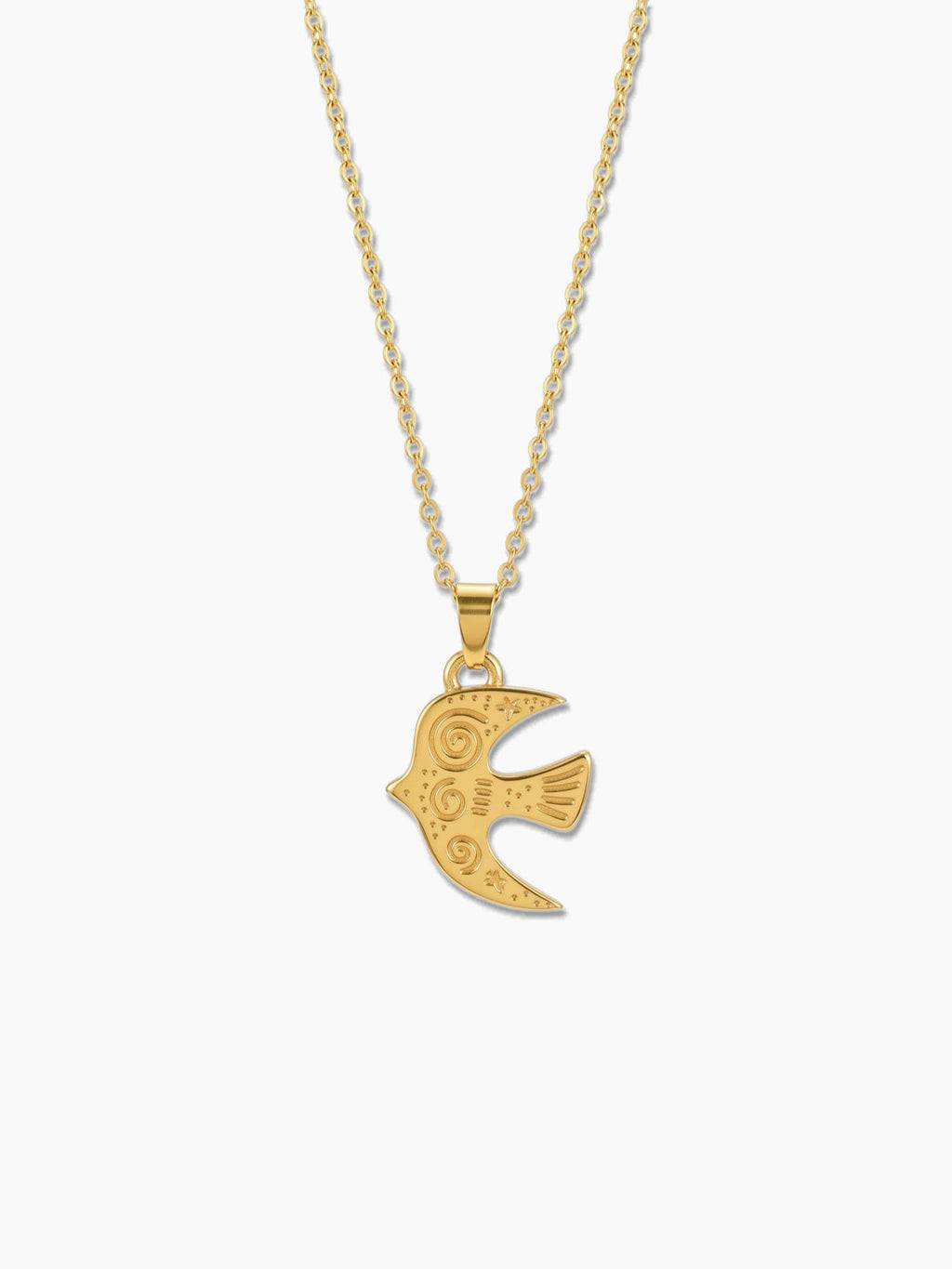 A detailed studio product shot of a vintage 18K gold bird necklace pendant with intricate tribal spiral engravings against a clean white background