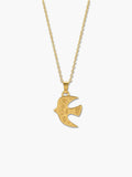 A detailed studio product shot of a vintage 18K gold bird necklace pendant with intricate tribal spiral engravings against a clean white background