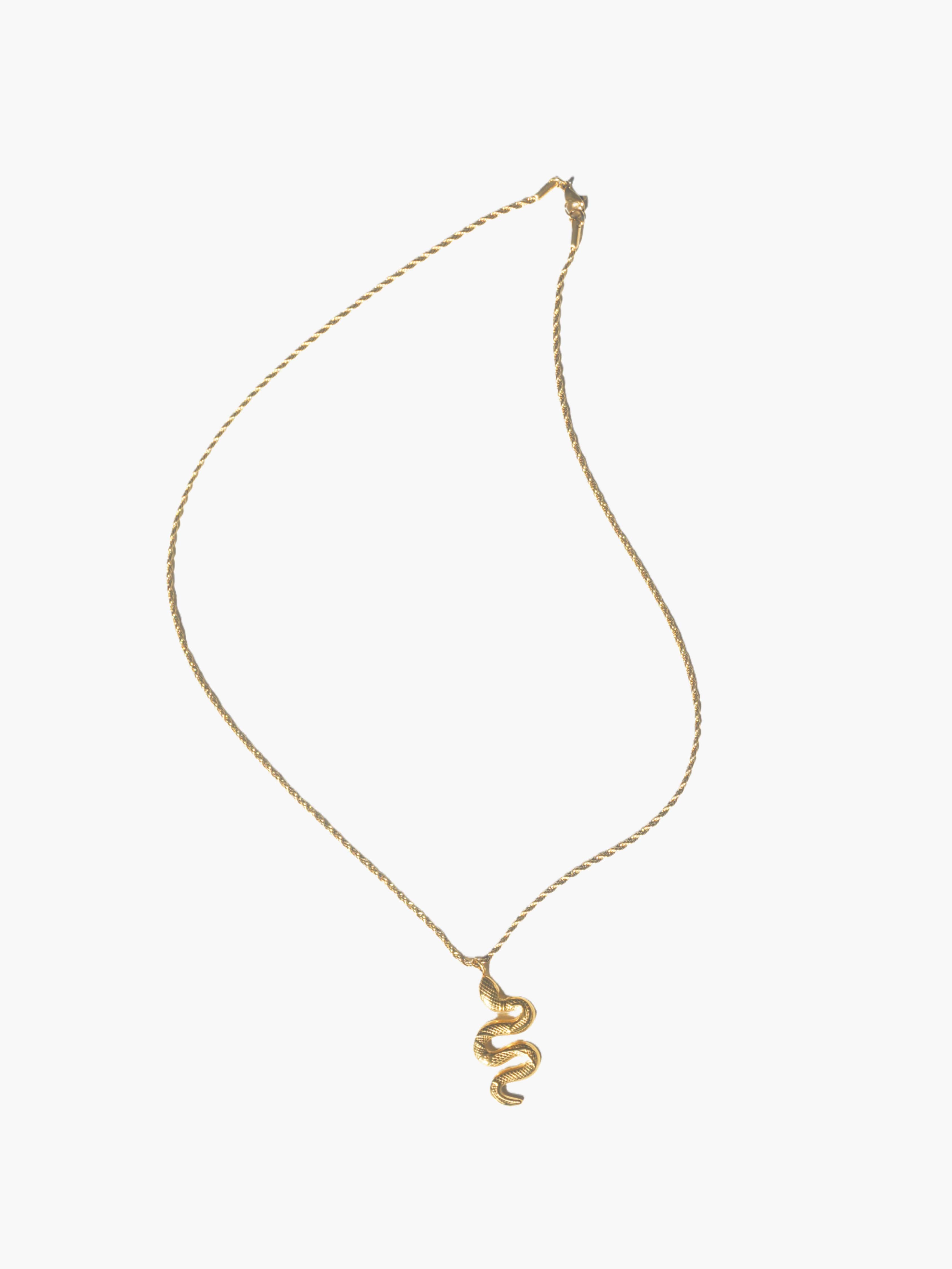 gold snake necklace on a white background