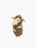 sheep wool felt ornament holding a white flower on a white background